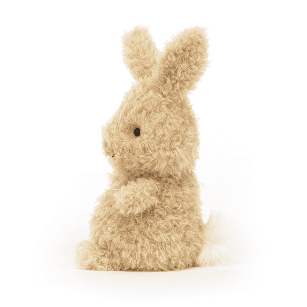 peluche petit lapin de coté sur fond blanc 